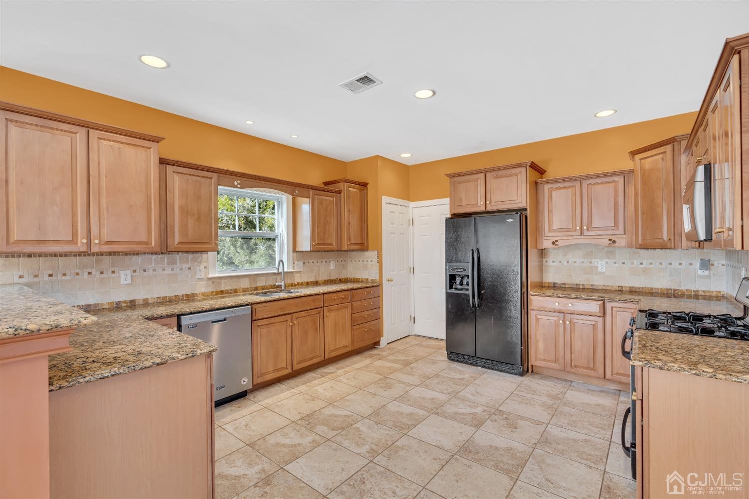 660 Ridge Road Monmouth Junction, NJ 08852 - Photo 19 of 52 a kitchen with stainless steel appliances granite countertop a refrigerator and a stove top oven