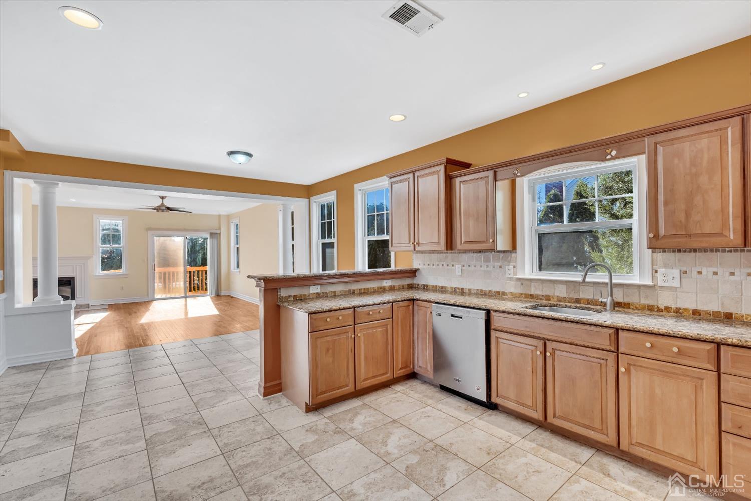 660 Ridge Road Monmouth Junction, NJ 08852 - Photo 22 of 52 a large kitchen with granite countertop a sink and dishwasher a stove top oven with wooden floor