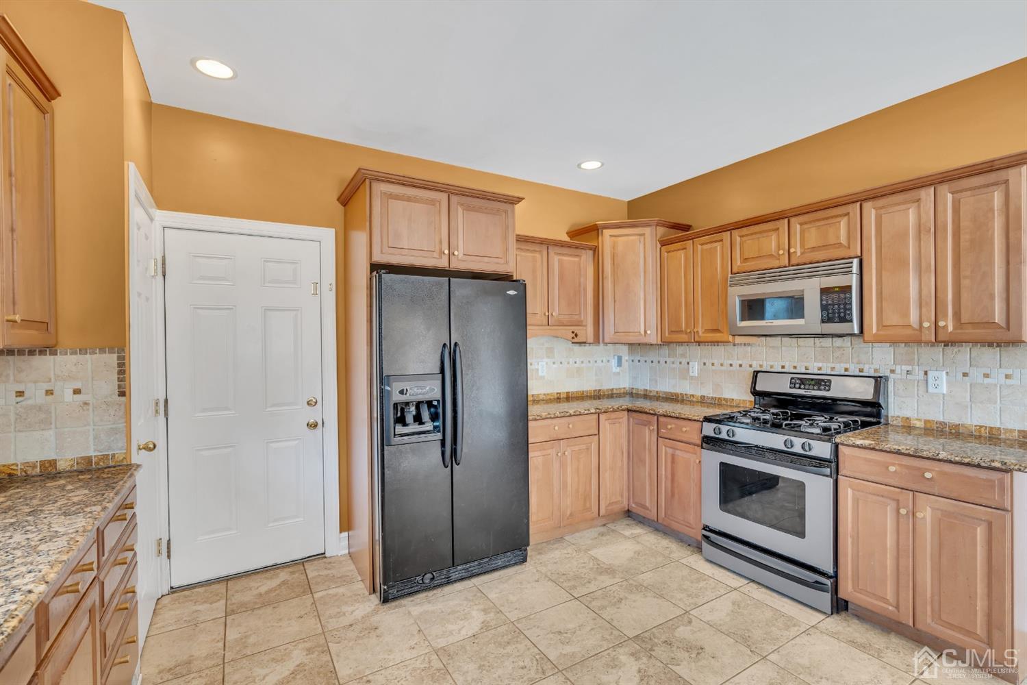 660 Ridge Road Monmouth Junction, NJ 08852 - Photo 24 of 52 a kitchen with stainless steel appliances granite countertop a refrigerator and a stove top oven