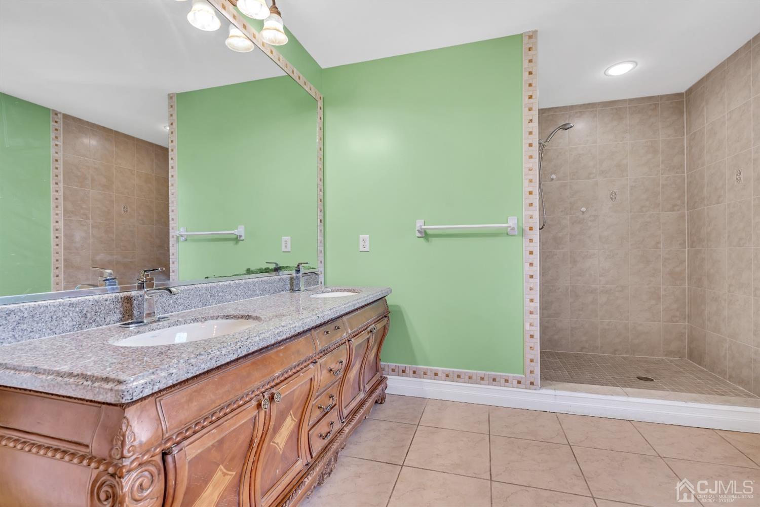 660 Ridge Road Monmouth Junction, NJ 08852 - Photo 31 of 52 a bathroom with a granite countertop sink and a mirror
