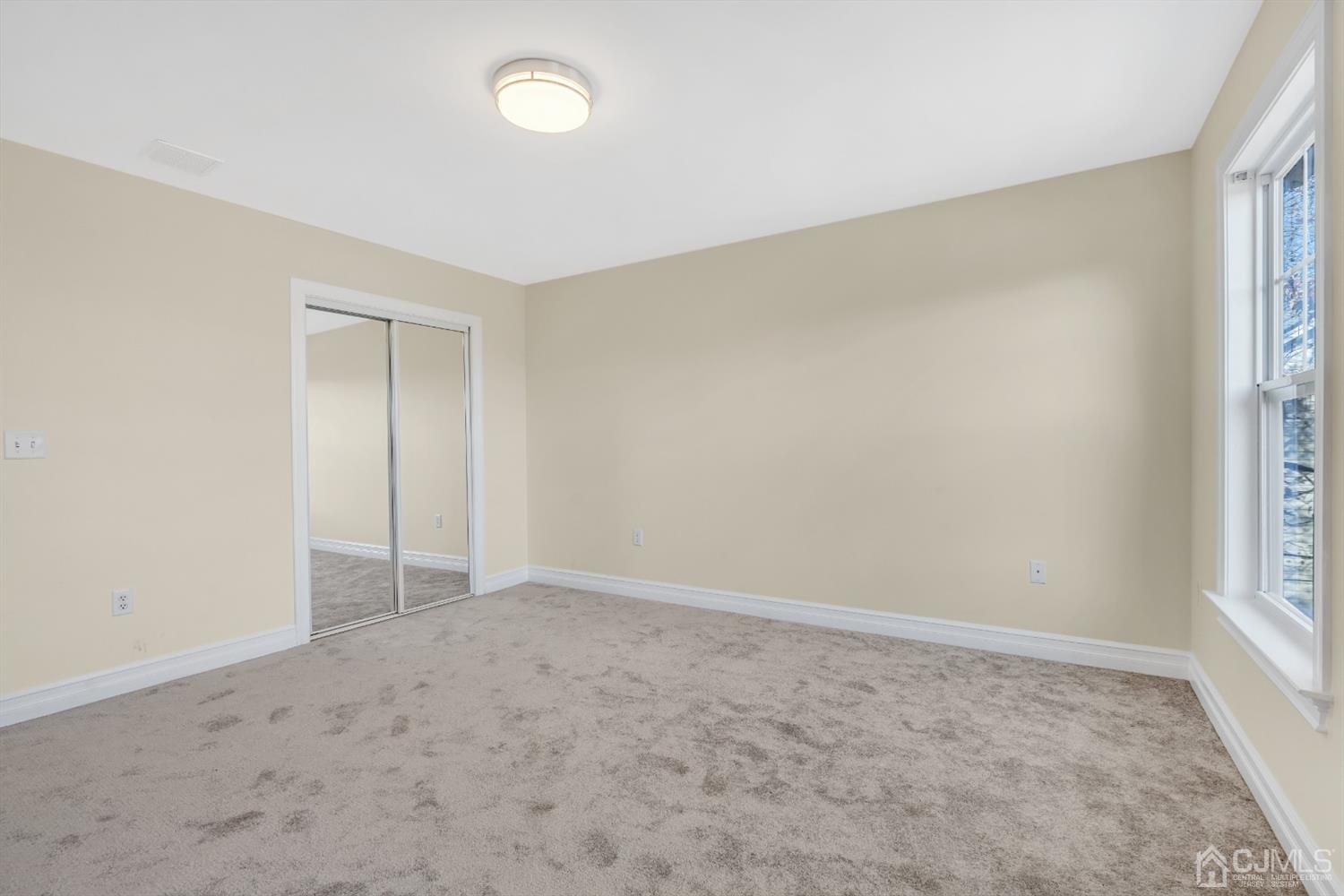 660 Ridge Road Monmouth Junction, NJ 08852 - Photo 44 of 52 an empty room with windows and closet