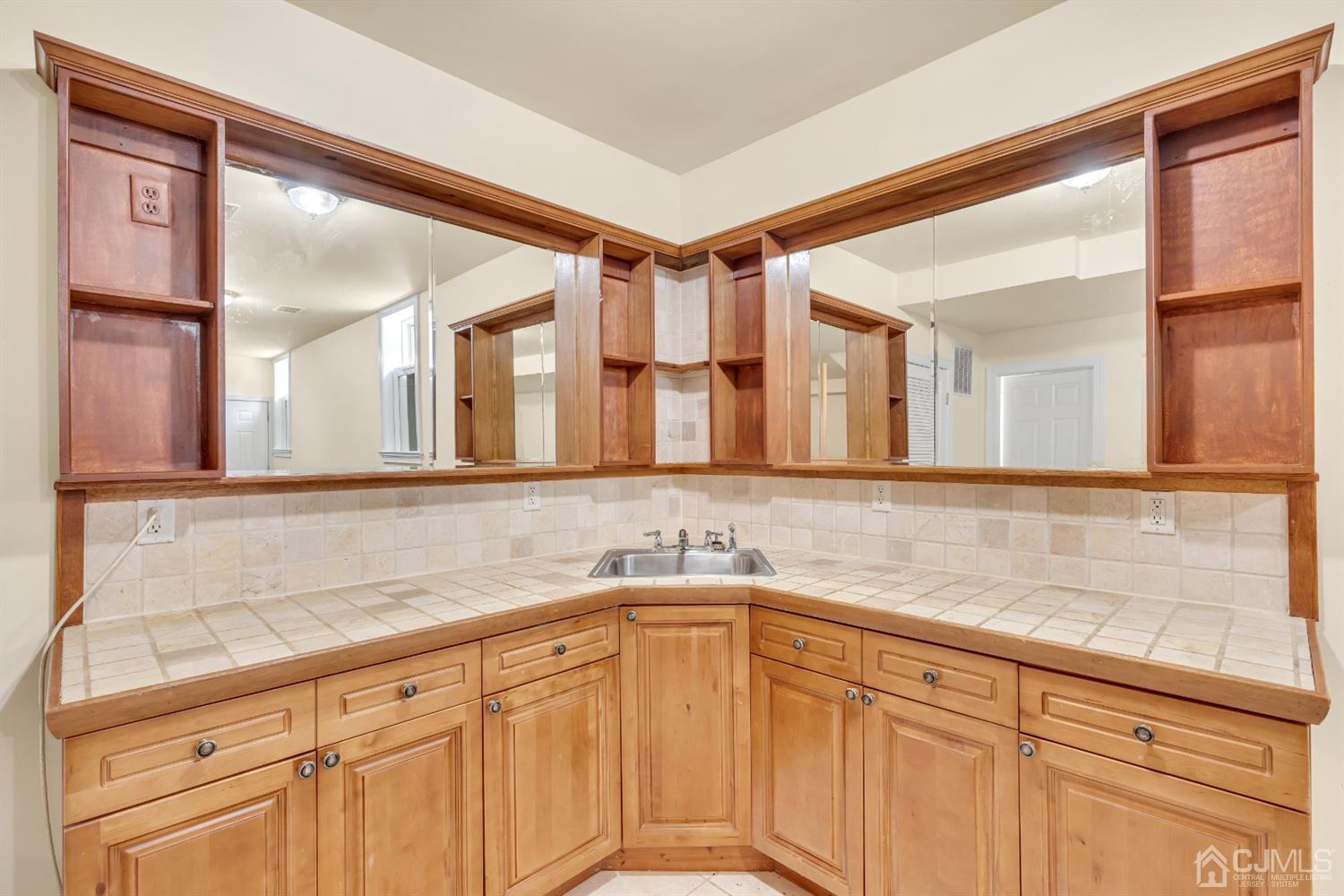 660 Ridge Road Monmouth Junction, NJ 08852 - Photo 50 of 52 a bathroom with a sink and a mirror