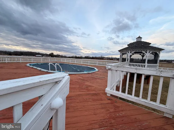 a roof deck with table and chairs