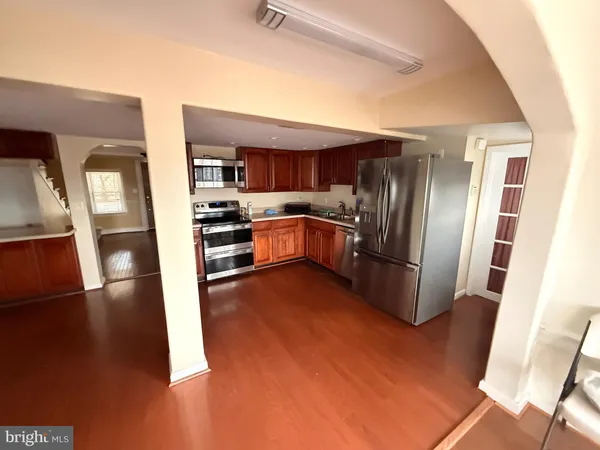 a kitchen with stainless steel appliances granite countertop a refrigerator and a stove