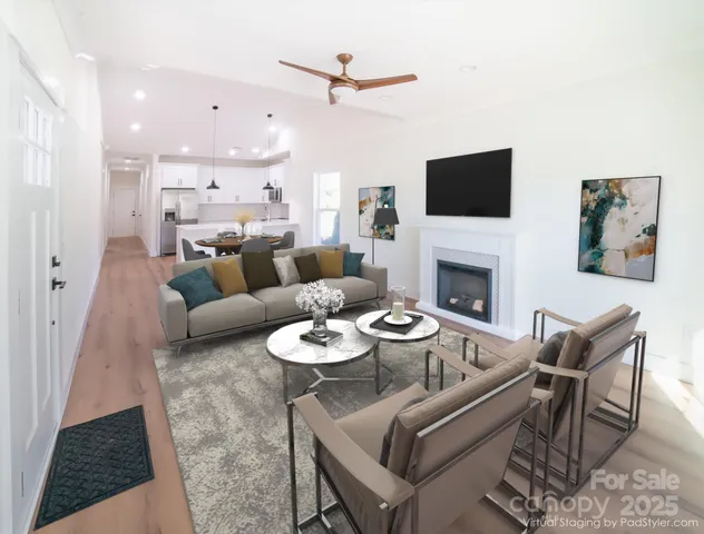 a living room with furniture a flat screen tv and a fireplace