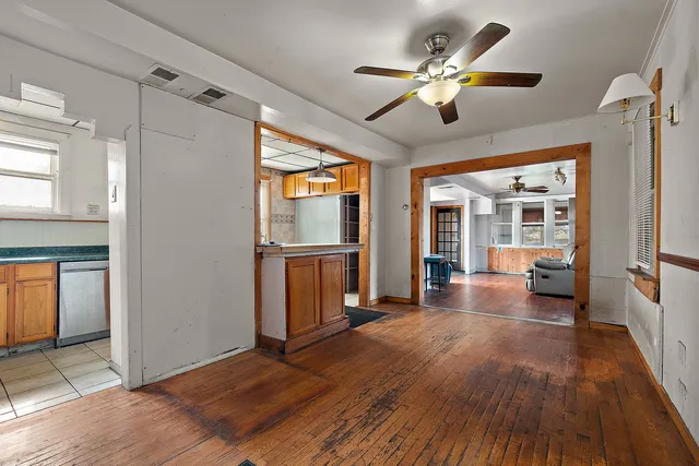 a view of a livingroom with wooden floor and a ceiling fan