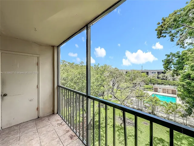 a living room with furniture and a ceiling fan
