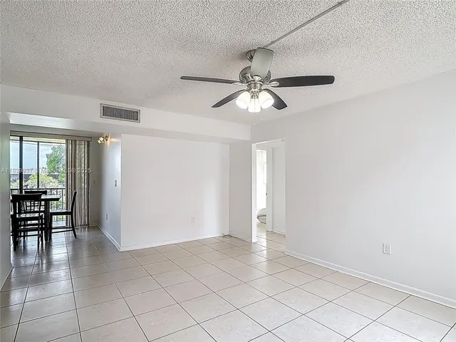 a kitchen with stainless steel appliances granite countertop a refrigerator a sink a stove a microwave and island