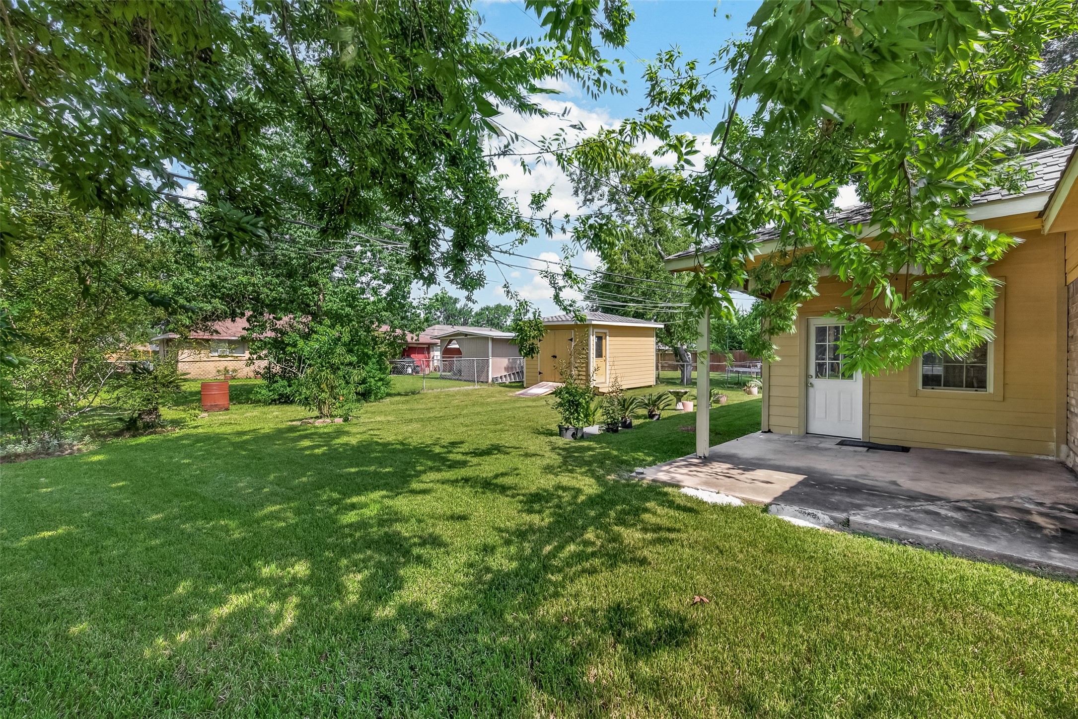 719 Kilpatrick Street Channelview, TX 77530 - Photo 36 of 40 The spacious backyard includes a covered patio, offering an ideal setting for outdoor entertaining.