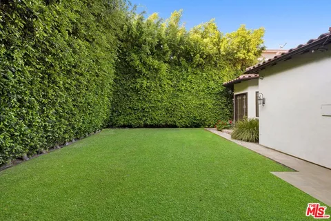 a view of yellow house with a yard