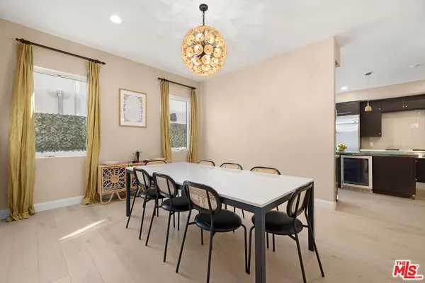 a view of a dining room with furniture and a chandelier