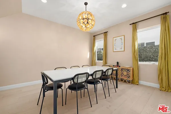 a view of a dining room with furniture and a window