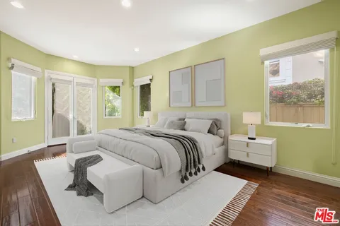 a spacious bedroom with a bed and a couch