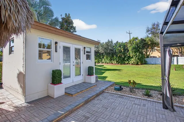 a view of a house with backyard porch and sitting area