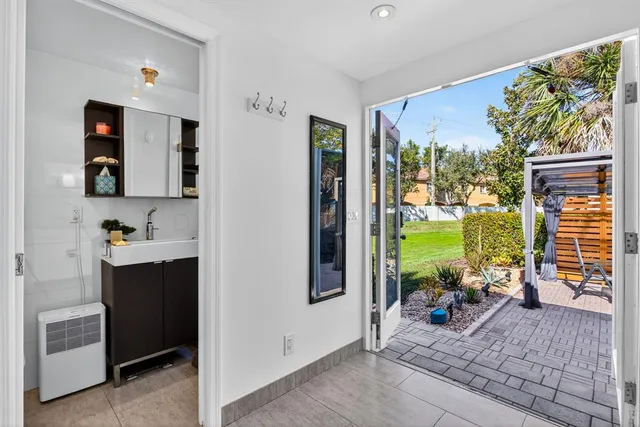 a hallway with a large window and sitting area