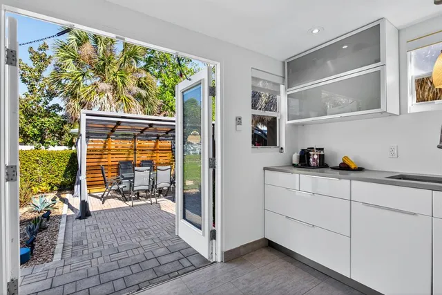 a view of a patio with a table chairs and a backyard