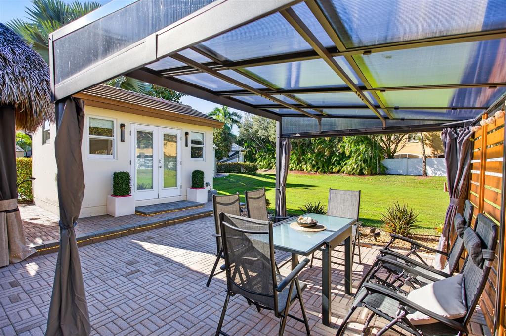 6 South Cortez Drive, Unit 6 Margate, FL 33068 - Photo 21 of 34 a view of a patio with a table chairs and a backyard