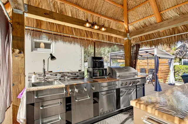 a kitchen with stainless steel appliances granite countertop a stove and a sink