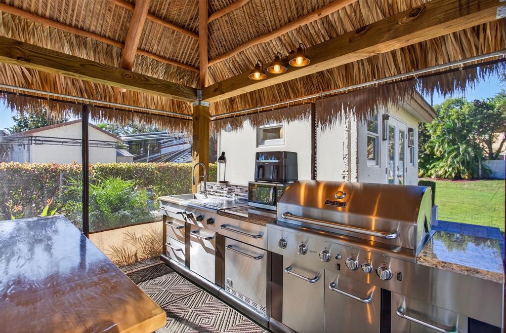 6 South Cortez Drive, Unit 6 Margate, FL 33068 - Photo 10 of 34 a view of a patio with table and chairs with wooden floor and fence