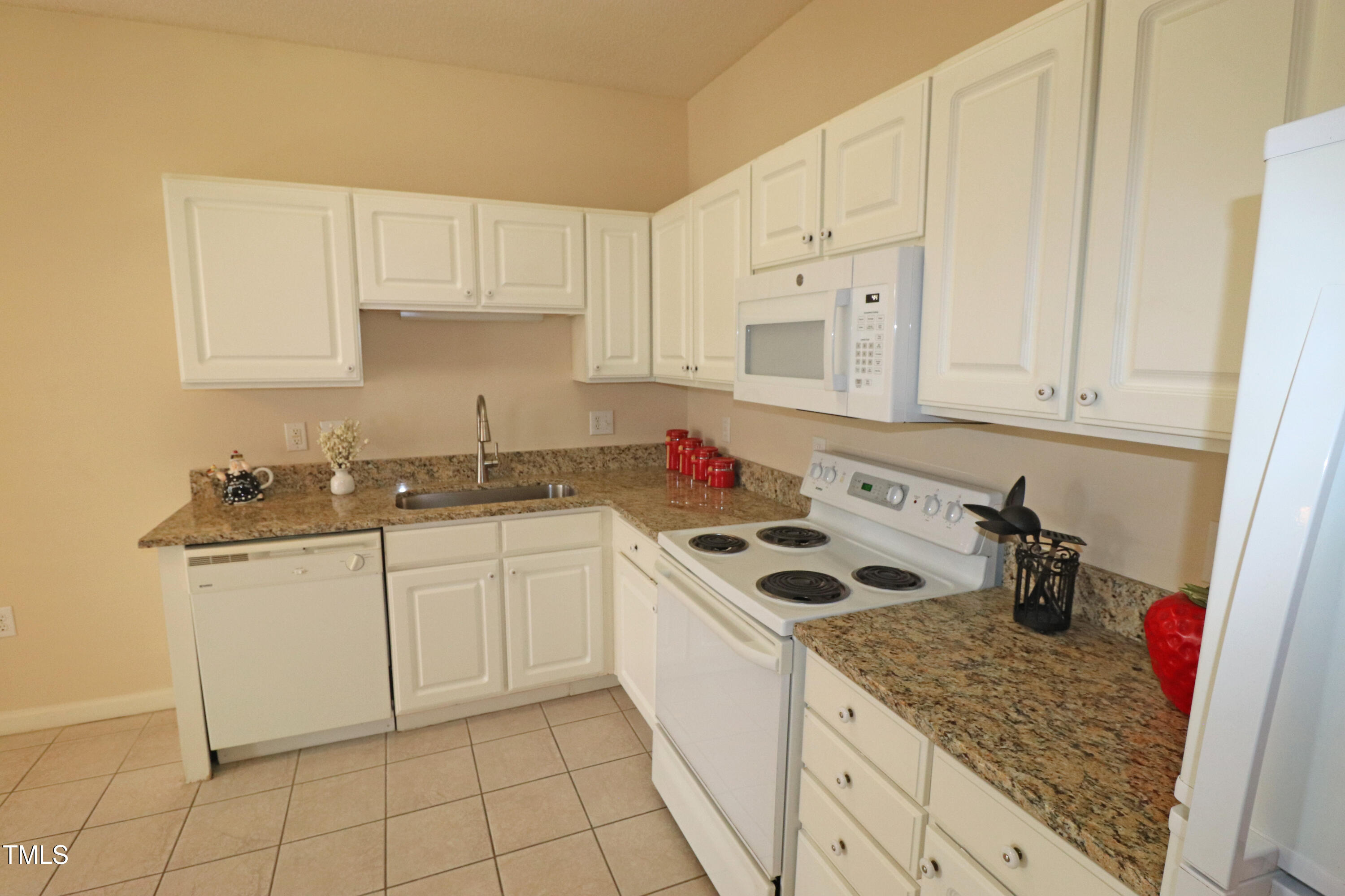 2520 Friedland Place, Unit 202 Raleigh, NC 27617 - Photo 13 of 32 a kitchen with stainless steel appliances granite countertop a sink stove and white cabinets