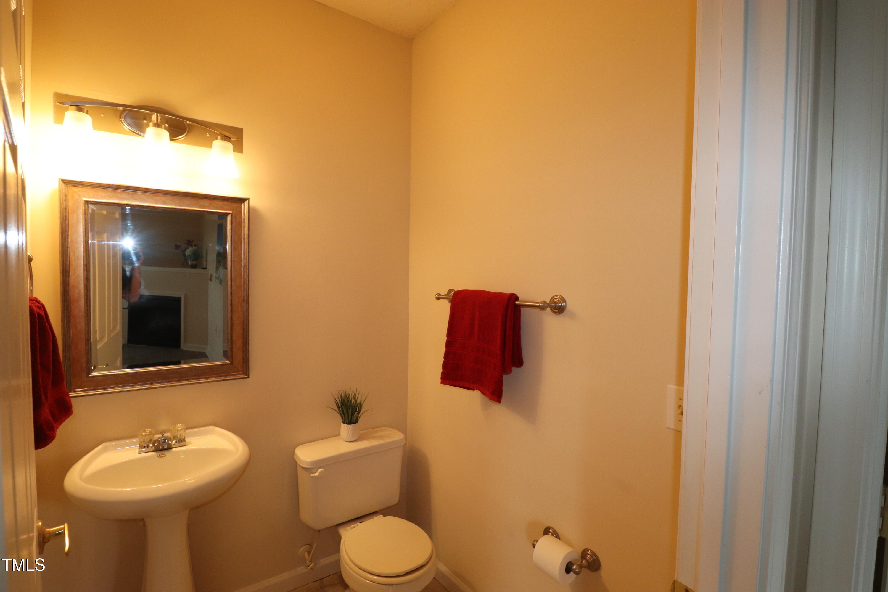 2520 Friedland Place, Unit 202 Raleigh, NC 27617 - Photo 15 of 32 a bathroom with a toilet sink and mirror