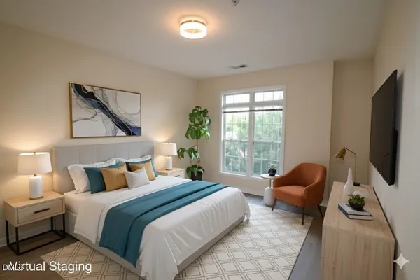 a bedroom with a bed and a flat tv screen on dresser