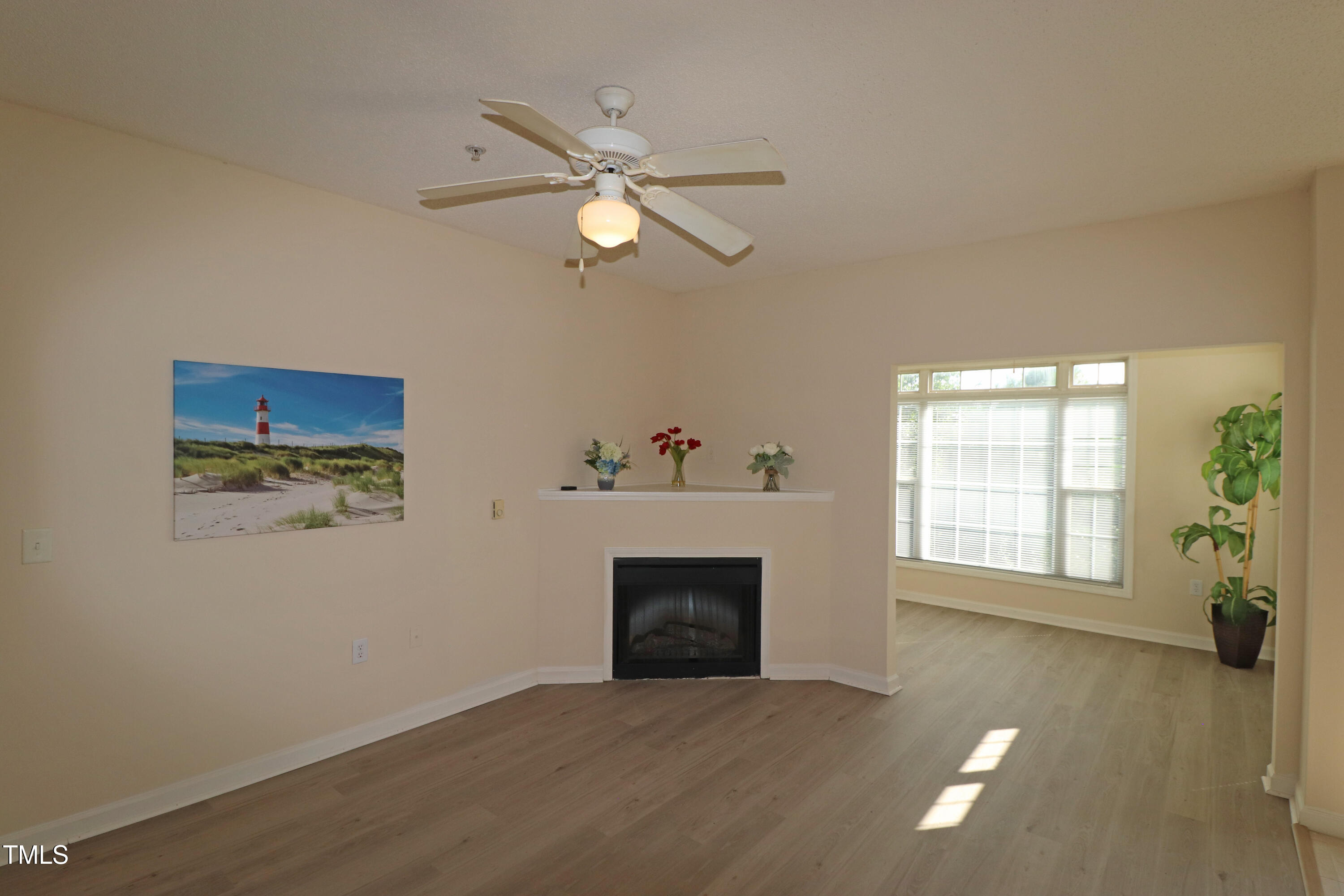 2520 Friedland Place, Unit 202 Raleigh, NC 27617 - Photo 2 of 32 a view of an empty room with a window and fireplace