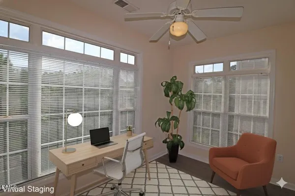 a view of a livingroom with furniture and a potted plant