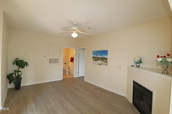 a view of a livingroom with furniture a fireplace and wooden floor