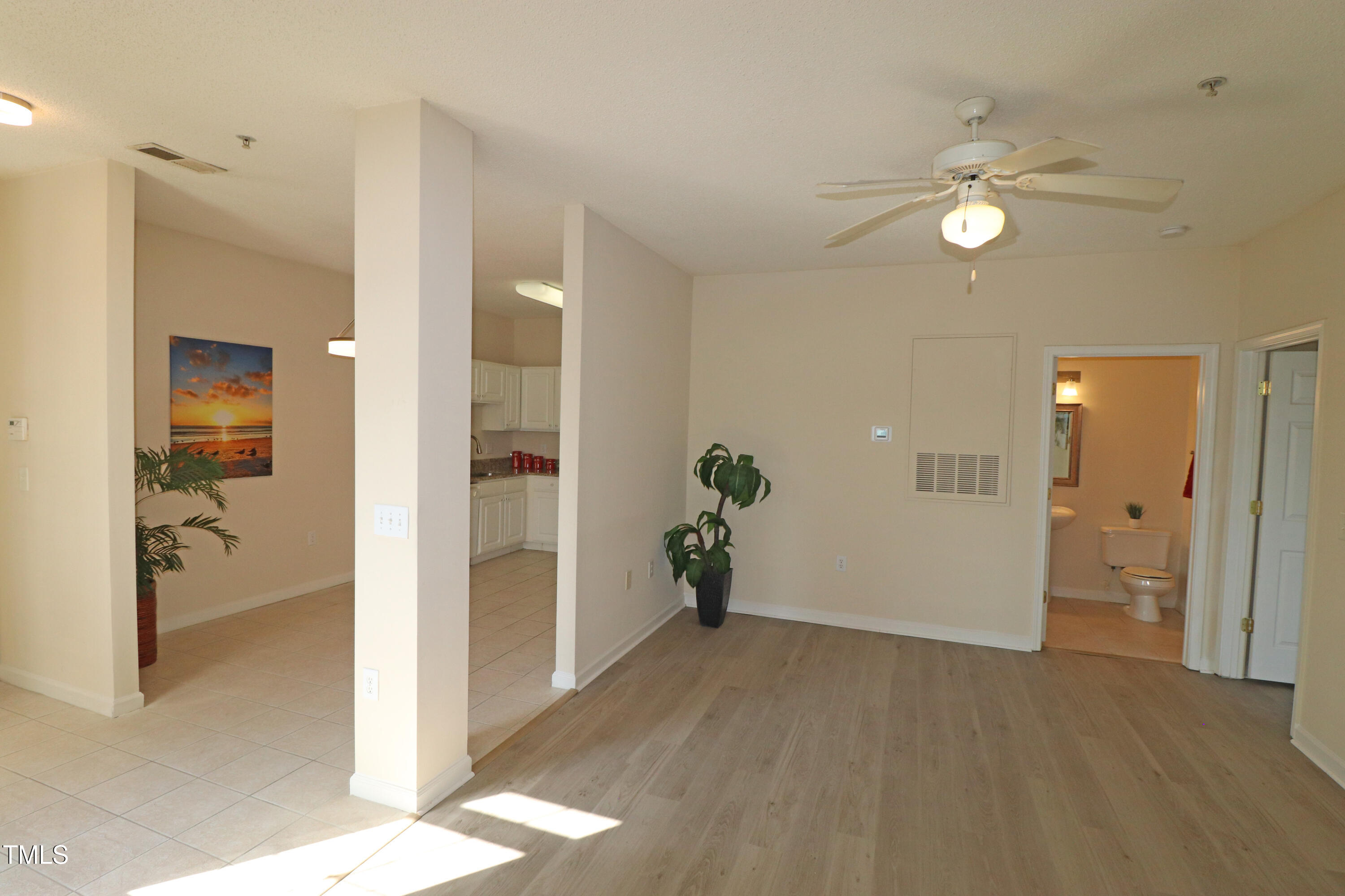 2520 Friedland Place, Unit 202 Raleigh, NC 27617 - Photo 5 of 32 a view of a hallway with wooden floor and a bathroom