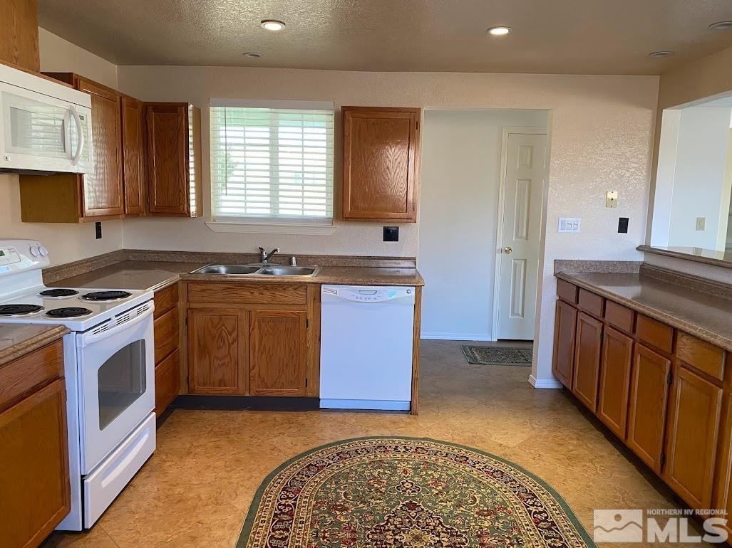 2255 Ward Place Reno, NV 89503 - Photo 2 of 13 a kitchen with stainless steel appliances granite countertop a stove a sink and a refrigerator
