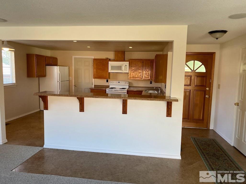 2255 Ward Place Reno, NV 89503 - Photo 4 of 13 a view of living room with kitchen island furniture and flat screen tv