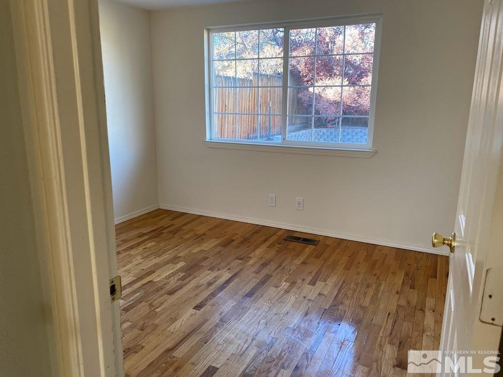 2255 Ward Place Reno, NV 89503 - Photo 9 of 13 an empty room with wooden floor and windows