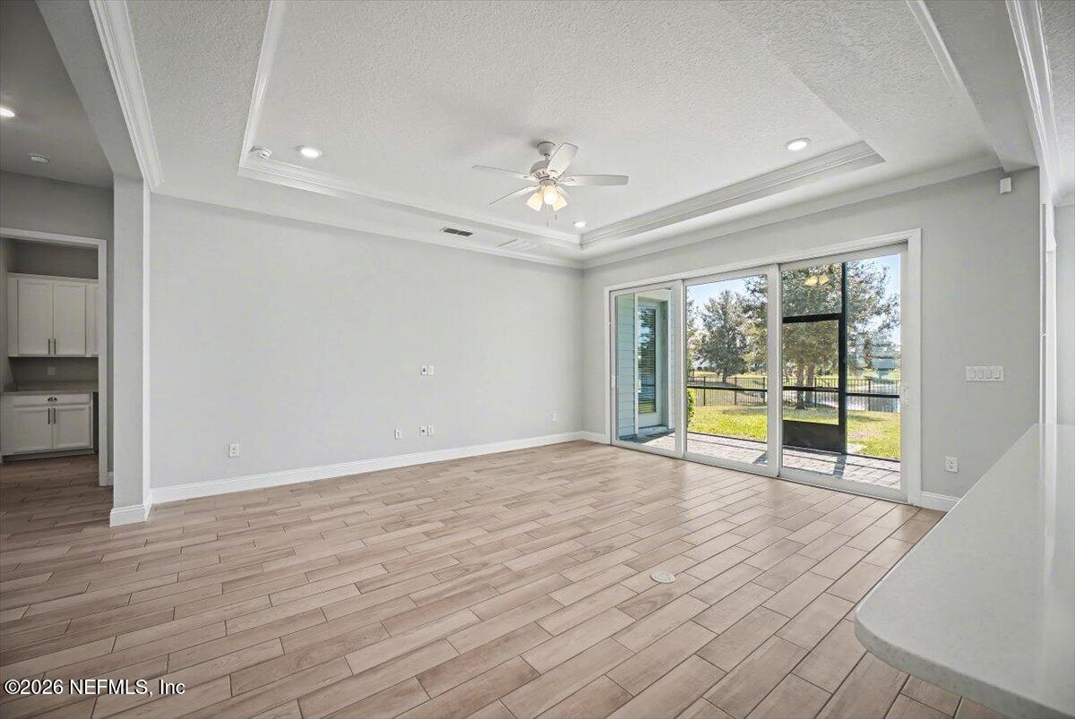 282 Caribbean Place St. Johns, FL 32259 - Photo 11 of 56 wooden floor in an empty room with a window