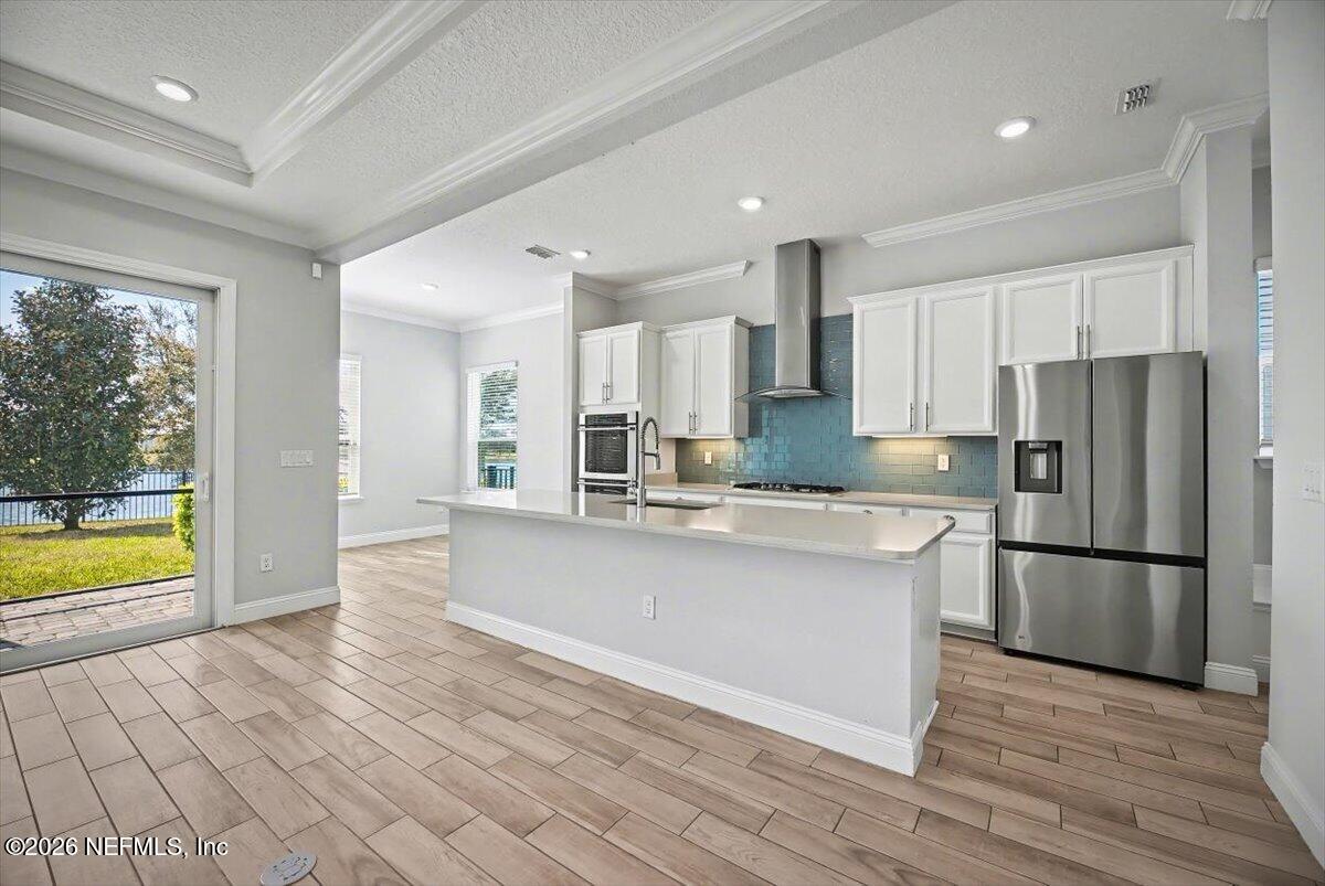 282 Caribbean Place St. Johns, FL 32259 - Photo 13 of 56 a kitchen with stainless steel appliances granite countertop a refrigerator and a stove top oven