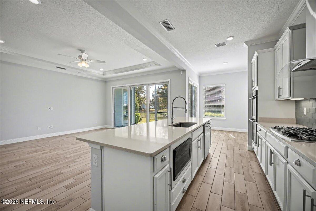 282 Caribbean Place St. Johns, FL 32259 - Photo 14 of 56 a kitchen with granite countertop a sink stove and refrigerator