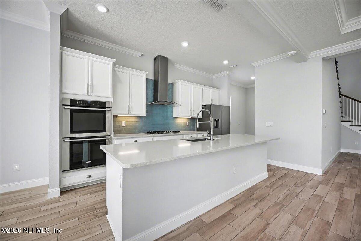 282 Caribbean Place St. Johns, FL 32259 - Photo 16 of 56 a large kitchen with stainless steel appliances a stove a sink and a refrigerator