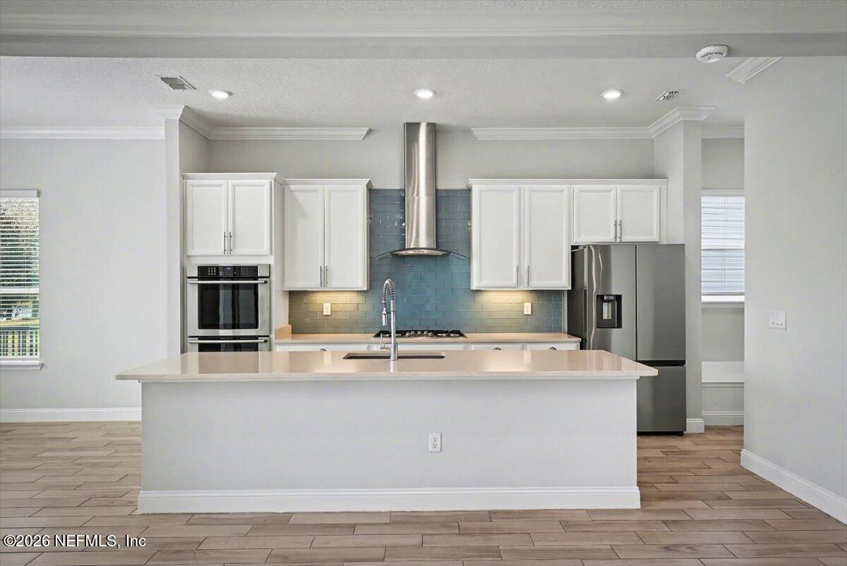 282 Caribbean Place St. Johns, FL 32259 - Photo 17 of 56 a kitchen with kitchen island stainless steel appliances a sink and refrigerator