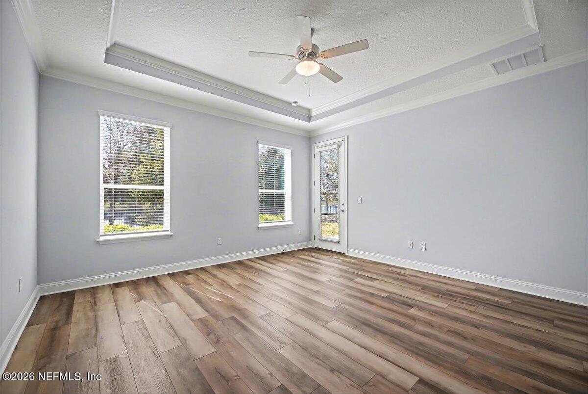 282 Caribbean Place St. Johns, FL 32259 - Photo 21 of 56 a view of an empty room with a window and wooden floor