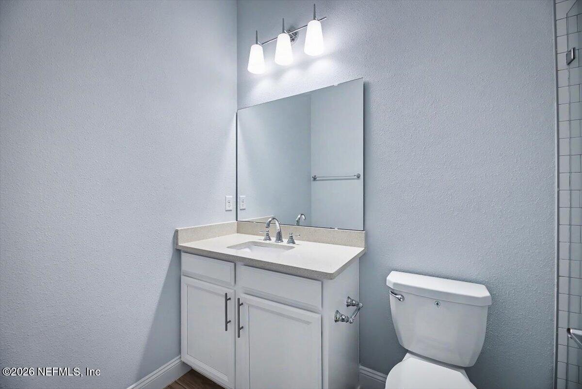 282 Caribbean Place St. Johns, FL 32259 - Photo 28 of 56 a bathroom with a toilet sink and mirror