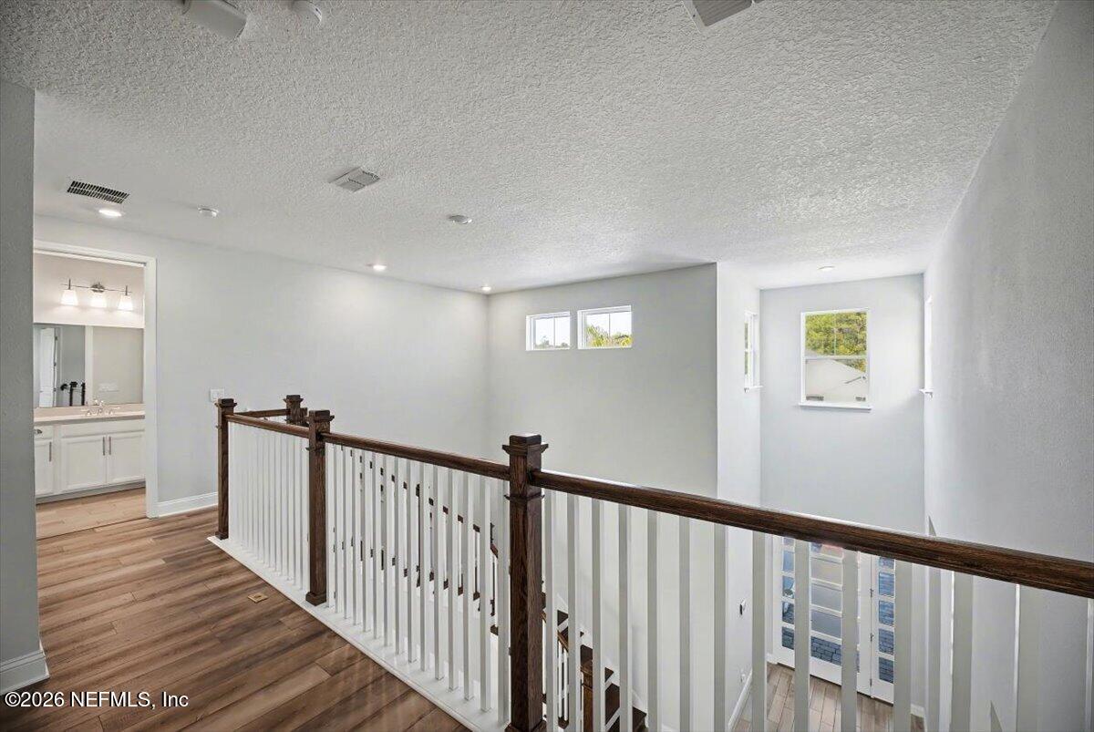282 Caribbean Place St. Johns, FL 32259 - Photo 30 of 56 a view of a hallway with wooden floor and a bathroom