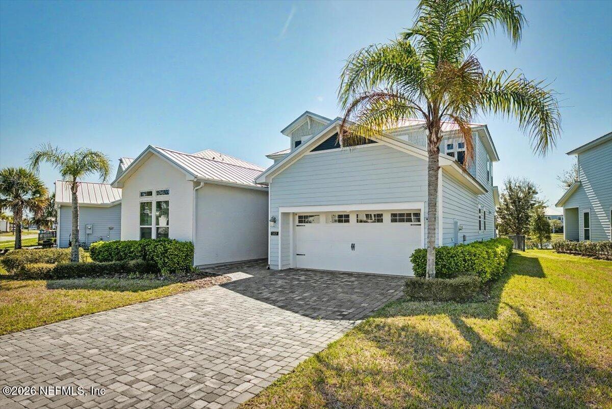 282 Caribbean Place St. Johns, FL 32259 - Photo 4 of 56 a view of a house with a yard and palm trees