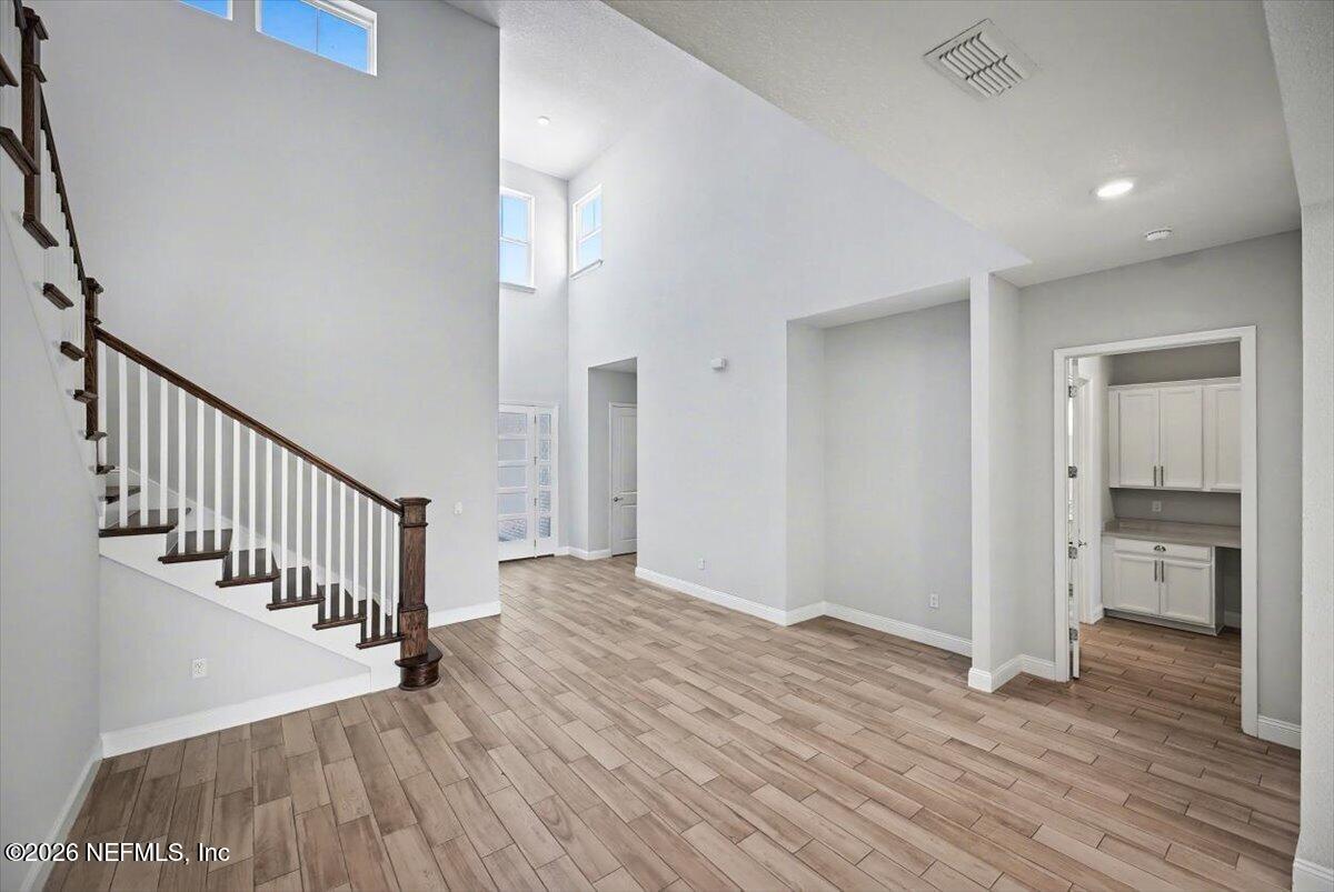 282 Caribbean Place St. Johns, FL 32259 - Photo 8 of 56 a view of a hallway with wooden floor and staircase