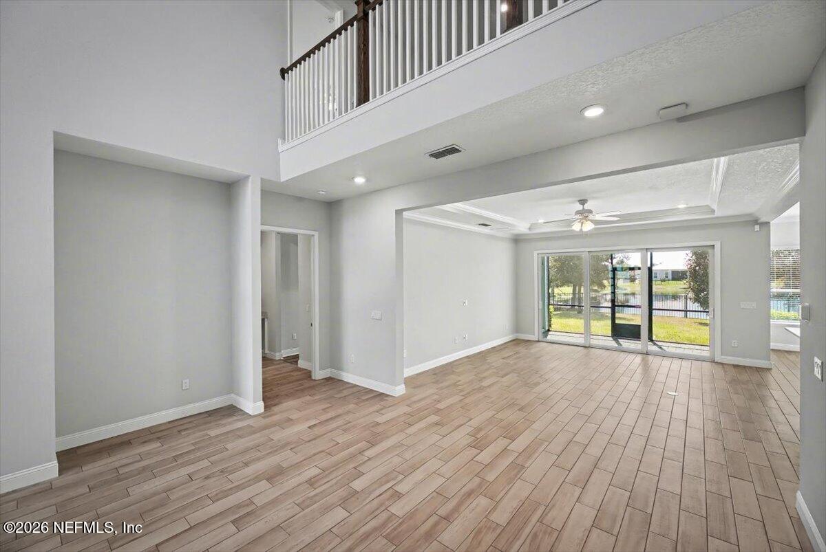 282 Caribbean Place St. Johns, FL 32259 - Photo 9 of 56 a view of an empty room with wooden floor and a window
