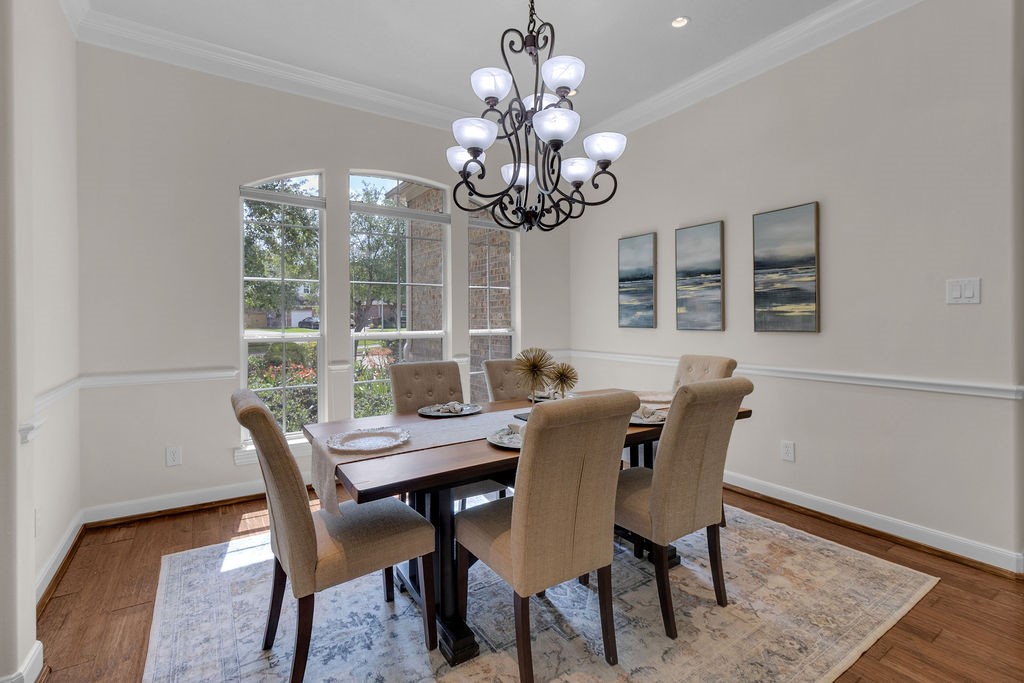 7306 Starflower Katy, TX 77494 - Photo 7 of 50 a view of a dining room with furniture a chandelier and wooden floor