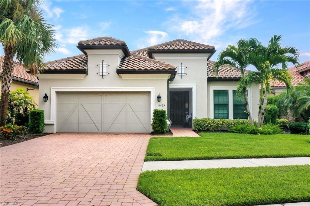 10163 Coconut Road Estero, FL 34135 - Photo 44 of 44 a front view of a house with a yard and garage