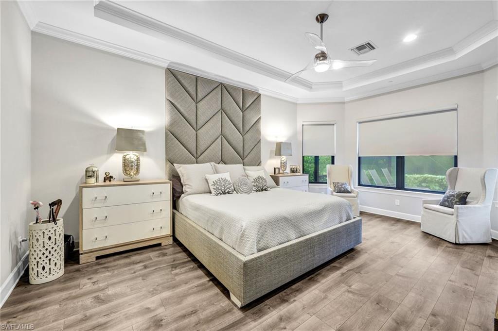10163 Coconut Road Estero, FL 34135 - Photo 16 of 44 a bedroom with a large bed and a large window