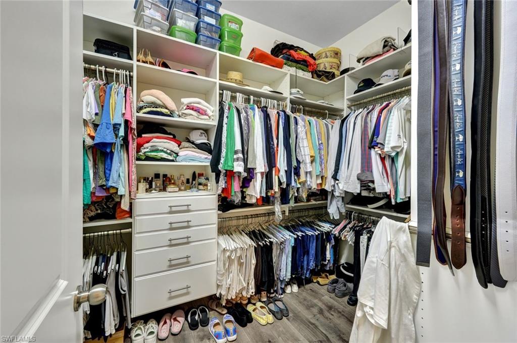 10163 Coconut Road Estero, FL 34135 - Photo 18 of 44 a view of walk in closet with clothes and shoes