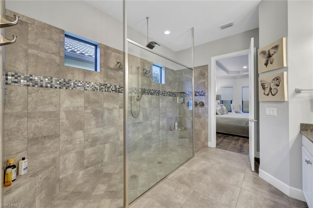 10163 Coconut Road Estero, FL 34135 - Photo 21 of 44 a en suite bathroom with a shower