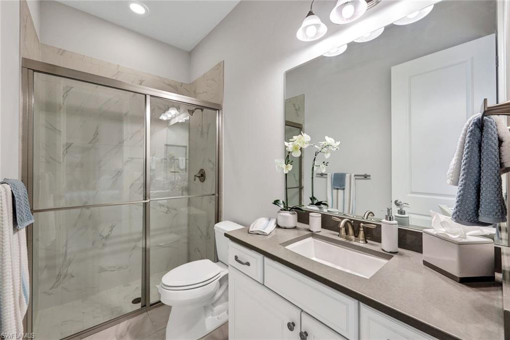 10163 Coconut Road Estero, FL 34135 - Photo 24 of 44 a bathroom with a sink toilet and shower